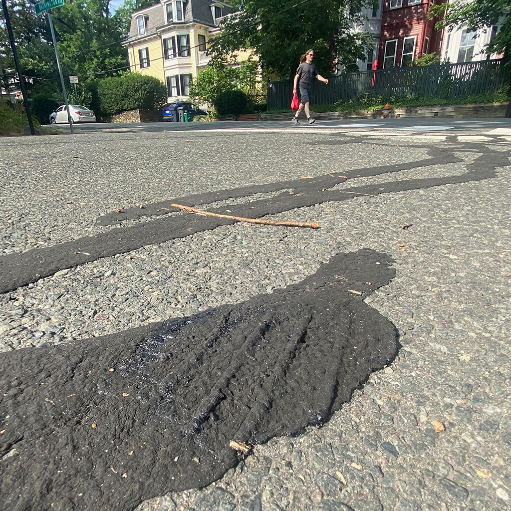 As the temperatures climbed, asphalt patchwork melted on roads in