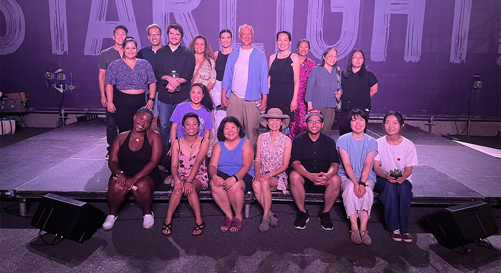 A diverse group of performers on stage, representing the collaborative and inclusive nature of autistic playwriting.